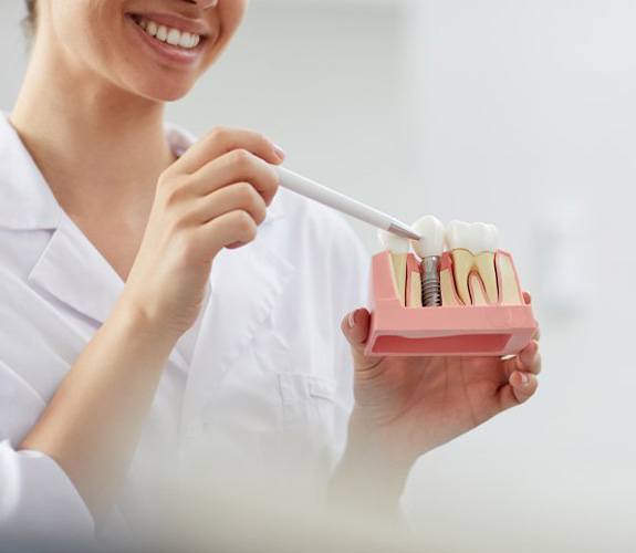 Dentist explaining dental implant care in Lockport
