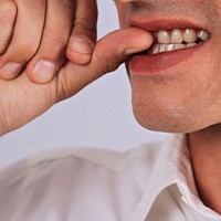 Man biting his fingernails