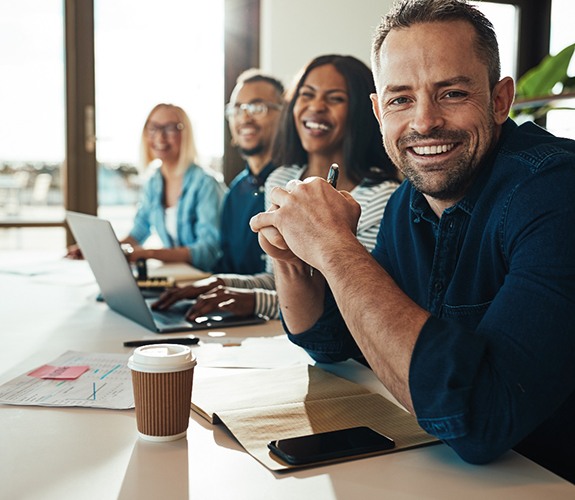 Man smiling with confidence at work