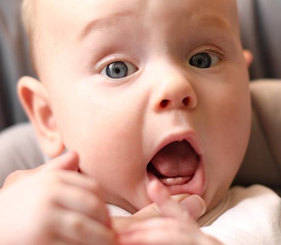 Dentist examining infant for lip and tongue tie