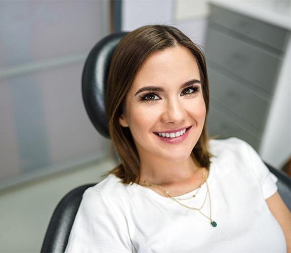 Young woman in chair visiting her dentist in Wilmington, IL