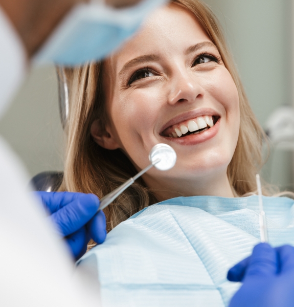 Woman in dental chair smiling at periodontist