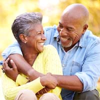 Couple smiling with dental implants in Lockport 