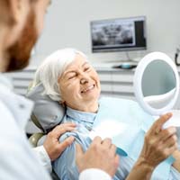 Woman with dental implants smiling in Lockport