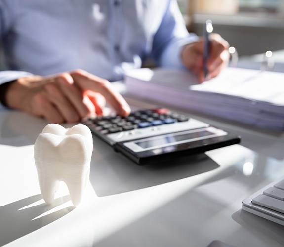 Man calculating dental insurance coverage