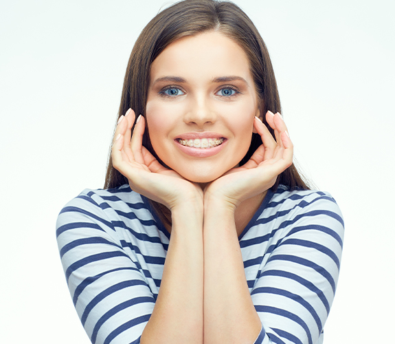 Woman with tooth colored braces smiling