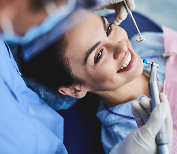 Woman receiving dental cleaning