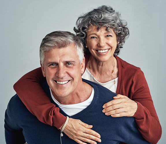 Man and woman with tooth colored fillings smiling