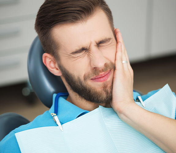 Man with toothache before root canal therapy