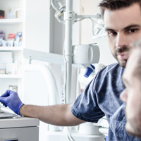 Dentist reviewing patient’s X-ray 