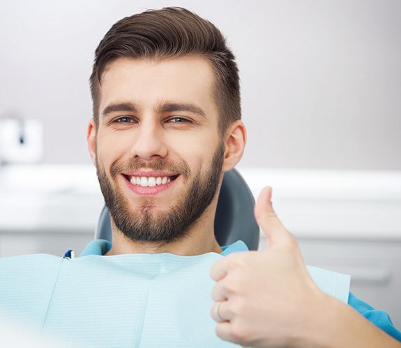 Happy dental patient enjoying benefits of laser dentistry