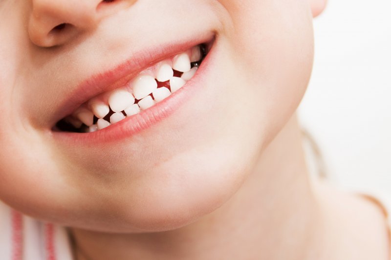 Close-up of a young child with baby teeth