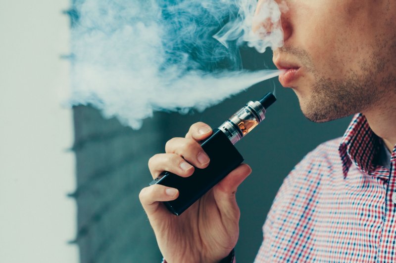 Man using electronic cigarette for vaping