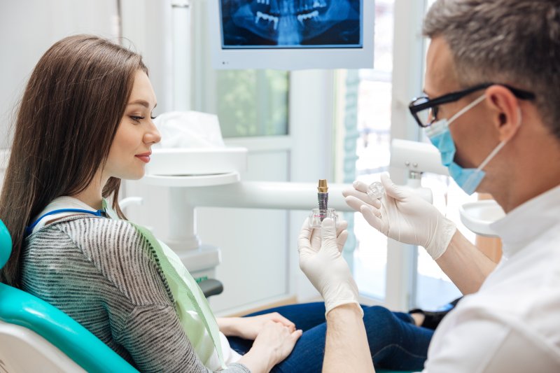 woman learning about dental implants