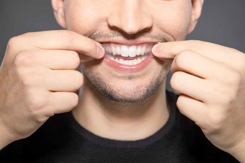 man using store-bought whitening strips 