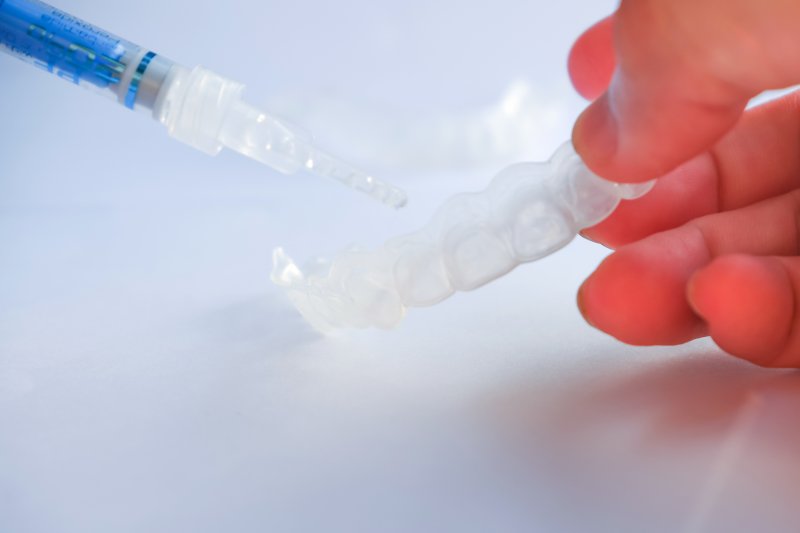 person using an at-home whitening kit