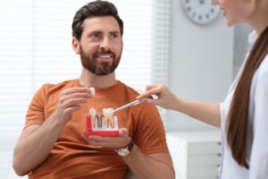 Man listening to dentist discuss dental implants